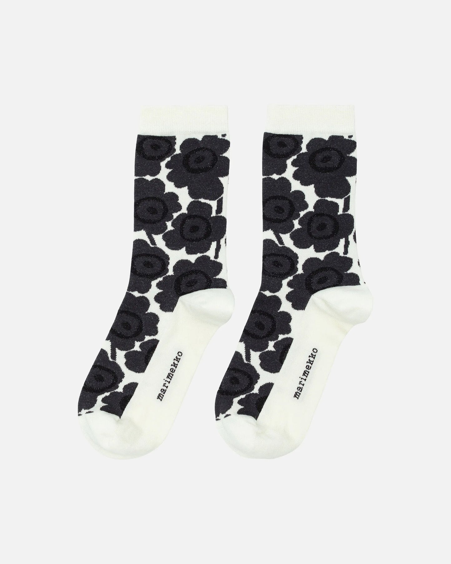 Pair of Marimekko socks with black floral pattern on a white background