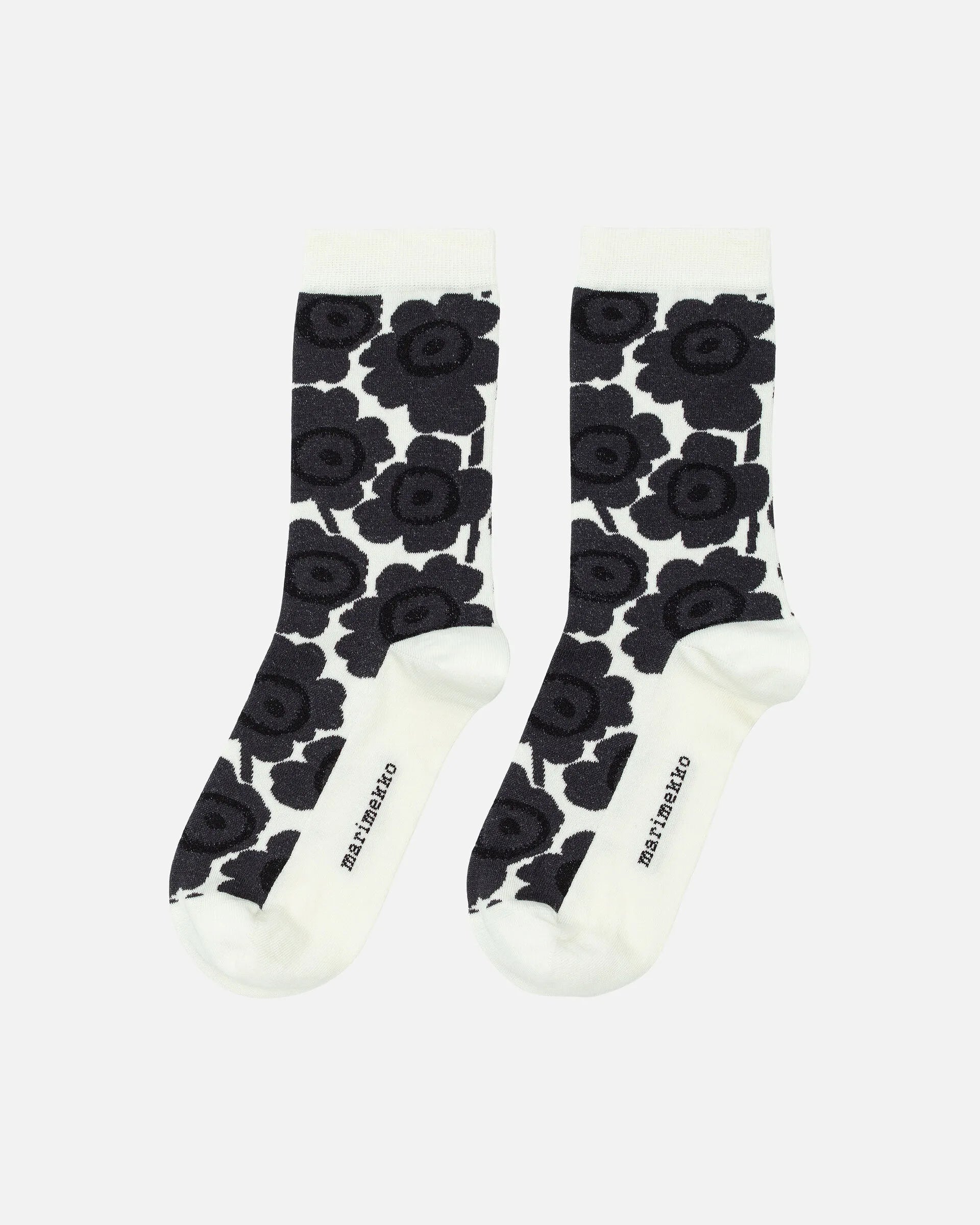 Pair of Marimekko socks with black floral pattern on a white background